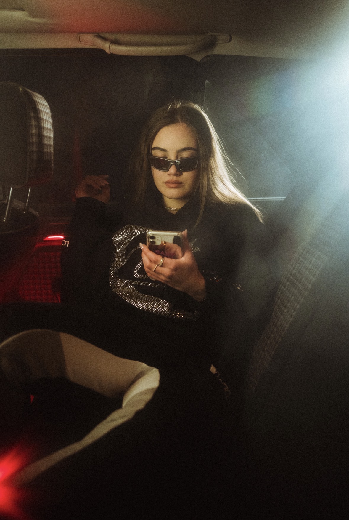 Model in a car at night